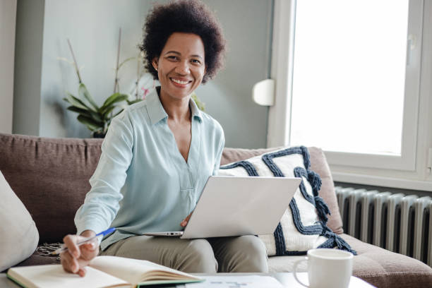 istock African-American woman working at home and concentrating work 1369411298