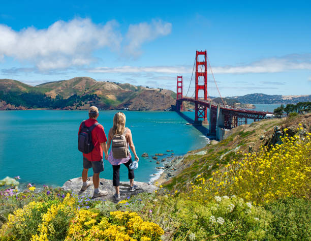 istock Couple holding hands looking at beautiful coastal landscape. 1369413111