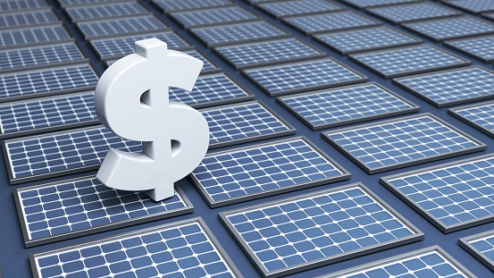 White-colored dollar symbol and solar panels. On dark blue-colored background. Horizontal composition with copy space.Focused image.