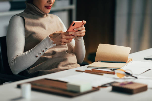 istock Anonymous Female Architect Browsing the Web on her Mobile Phone for Inspiration 1369414800