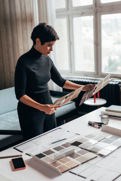 istock Beautiful Female Architect Choosing the Right Color Palette for her Project 1369414830