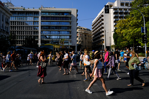 Crowd of people pass from pedestrians line during a hot day in central Athens, Greece on July 23, 2021.