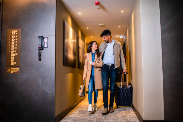 istock Hugging couple in a hotel hallway 1369417531