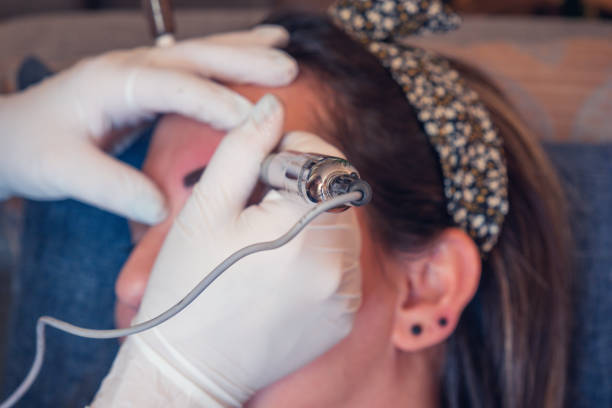 istock Woman is getting permanent makeup on her eyebrows 1369418386