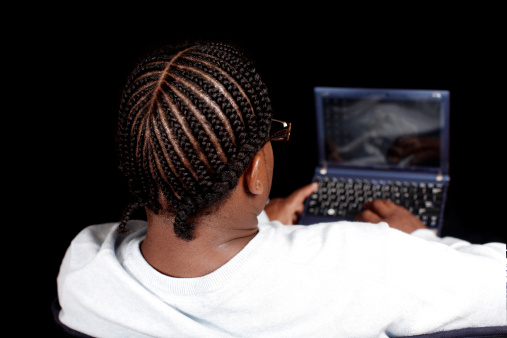 A young man using a laptop computer.