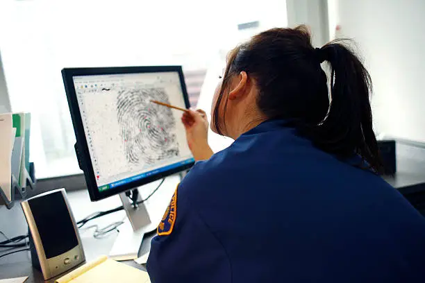 Photo of Officer viewing fingerprint