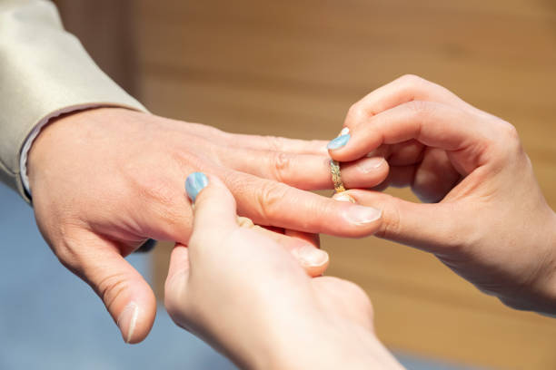 istock Up where the bride is wearing a ring on the groom 1369428167