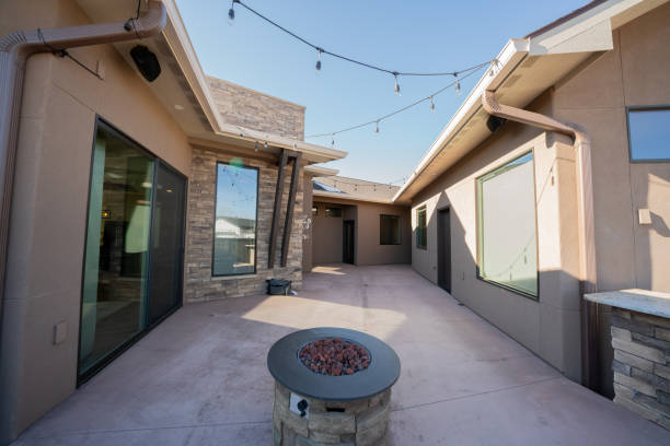 executive home exterior structural detail modern styling with cultured stone and stucco and fire pit in courtyard - indoors window courtyard elegance imagens e fotografias de stock