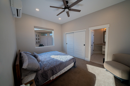 Fashionable Modern Bedroom in an Executive New Home with Ceiling Fan