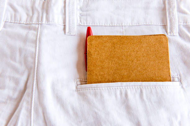 Diary and pen in white pants pocket.