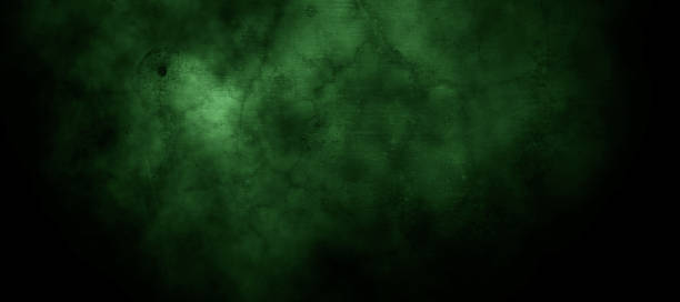 istock Scary dark green misty cracked wall for background 1369436959