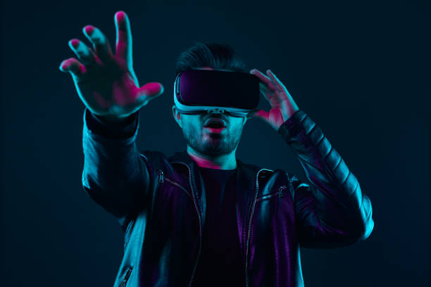 istock Amazed man in VR goggles interacting with cyberspace 1369437902