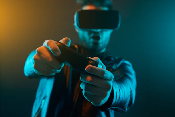 istock Man with joystick and VR goggles playing video game 1369437918
