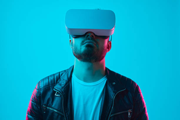 istock Trendy man in VR headset experiencing new technology 1369437954