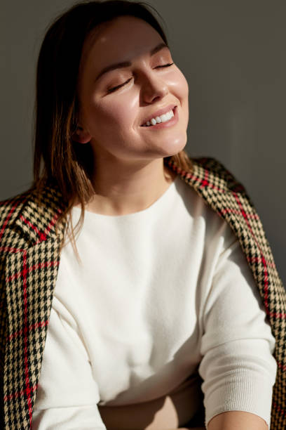 istock Tender woman enjoying sunlight in morning 1369437997