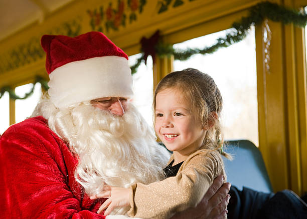 Young Girl Meets Santa on a Train stock photo