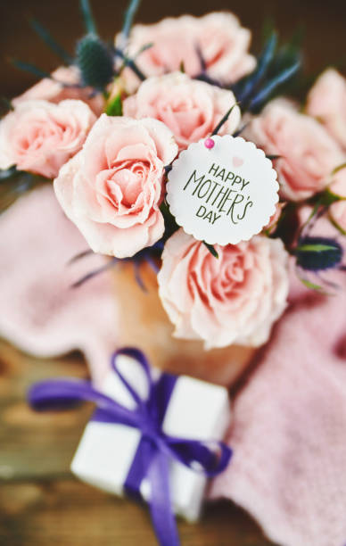 istock Delicate pink rose bouquet with gift and message for Mother's Day 1369461075