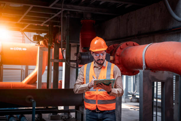 istock Industry engineer under checking the industry cooling tower air conditioner is water cooling tower air chiller HVAC of large industrial building to control air system. 1369464636