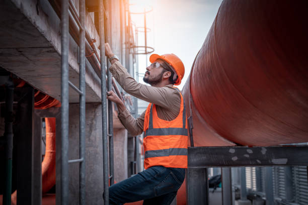 istock Industry engineer under checking the industry cooling tower air conditioner is water cooling tower air chiller HVAC of large industrial building to control air system. 1369464650