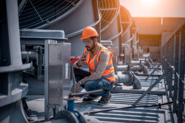 istock Industry engineer under checking the industry cooling tower air conditioner is water cooling tower air chiller HVAC of large industrial building to control air system. 1369464704