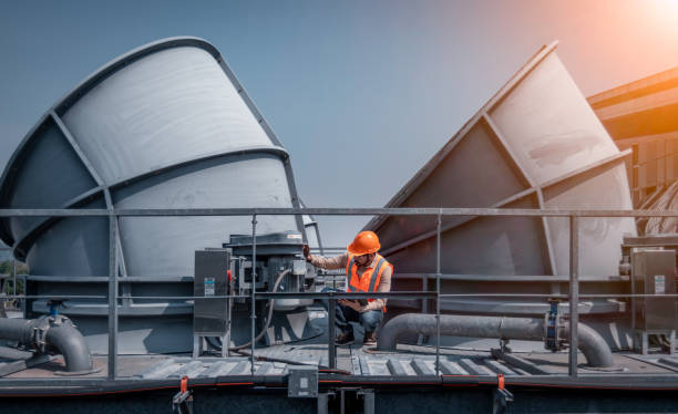 istock Industry engineer under checking the industry cooling tower air conditioner is water cooling tower air chiller HVAC of large industrial building to control air system. 1369464706