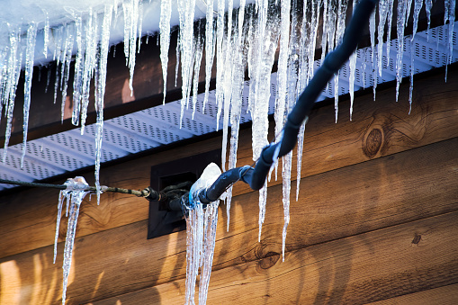 Icicles hanging from the roof in winter