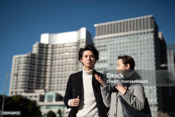 Two Business People Talking In Business District Stock Photo - Download Image Now - 30-34 Years, 35-39 Years, Adult