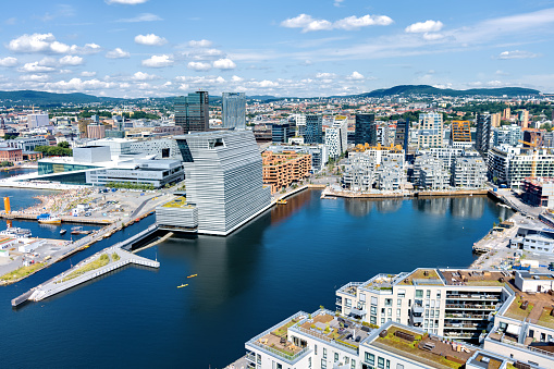 Oslo, Norway - July 13, 2021: City Oslo. Buildings on the left: Munch Museum, Oslo Opera House