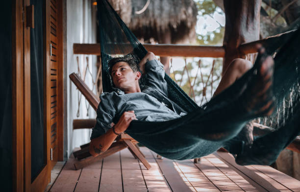 A Handsome Young Man Relaxing In A Hammock