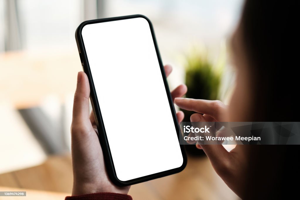 Business woman holding cell phone show something on display at cafe shop. Blank screen for your advertising. Business woman holding cell phone show something on display at cafe shop. Blank screen for your advertising Template Stock Photo
