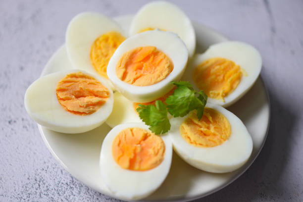 istock Eggs menu food boiled eggs in a white plate decorated with leaves green coriander, cut in half egg yolks for cooking healthy eating eggs breakfast 1369474430