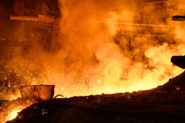 istock Molten metal flows through the channel. Blast furnace metal release 1369474636