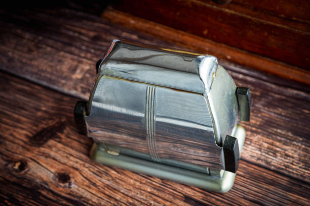 Old vintage electric bread toaster on wooden kitchen table Old vintage stainless steel electric bread toaster on wooden kitchen table. kitchen utensil antique toaster old stock pictures, royalty-free photos & images
