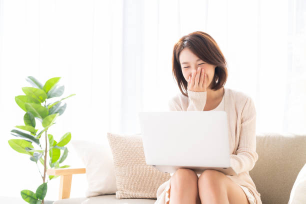 istock young asian woman using laptop 1369477440