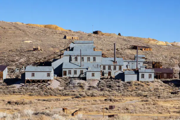 Old tin buildings of abandoned Gold Mine in Bodie Ghost town in the Easter Sierra Nevada Mountian Range.