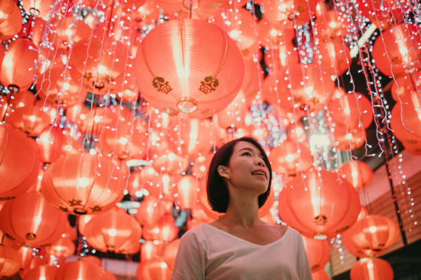 istock Woman with shining lanterns background. 1369478184