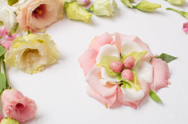 istock easter background with small eggs and pastel flowers on white 1369479254