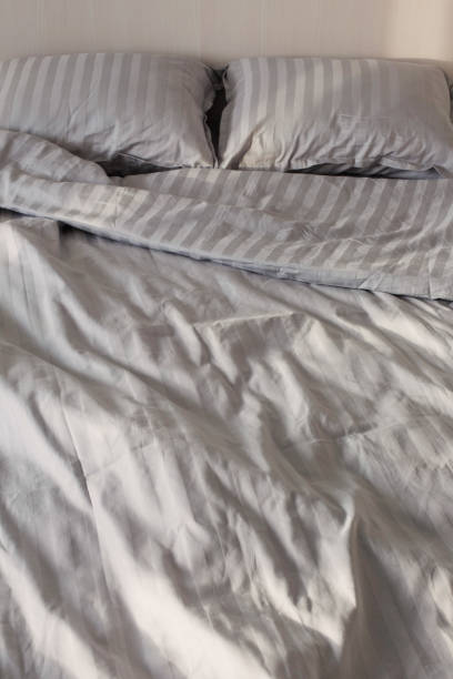 istock gray linens in sunlight on  bed in  bedroom 1369479269