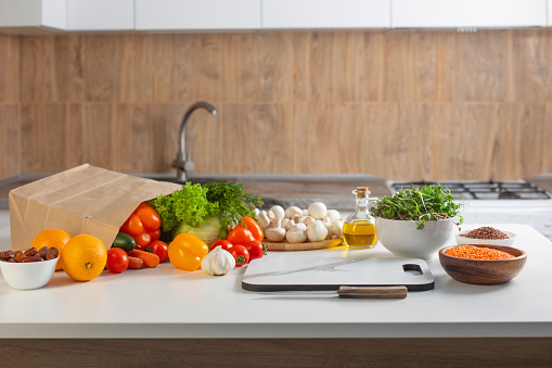 fresh health vegetarian food on white table in kitchen