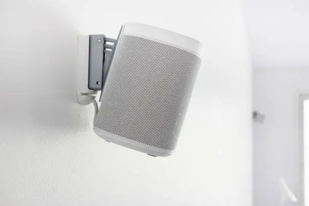 Wall mounted audio speaker on a white background.