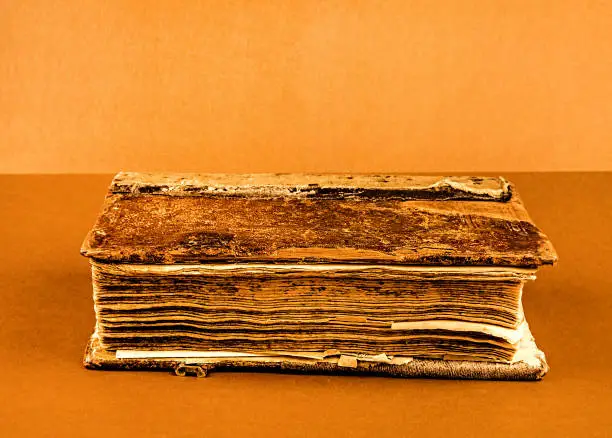 Toned Photo of the Old and Vintage Book on the Brown Background closeup