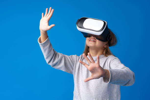 istock Girl with virtual reality glasses on blue background. 1369489519