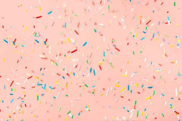 istock flying colorful sprinkles over pink background 1369494239