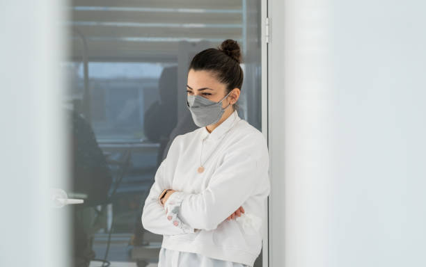 istock Woman Wearing Mask Standing Smiling 1369494255