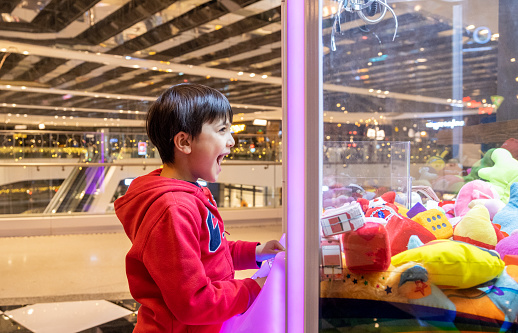 Excited Kid Boy Playing Toy Grabbing Game