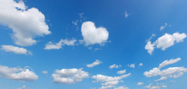 istock heart shape cloud over blue panoramic sky. love theme background. high resolution 1369496662