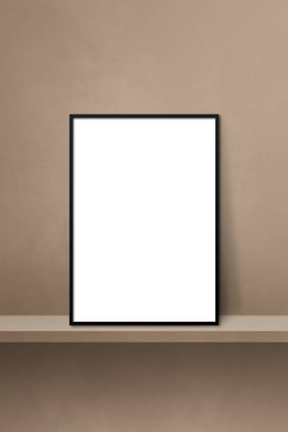 istock Black picture frame leaning on a brown shelf. 3d illustration. Vertical background 1369496711
