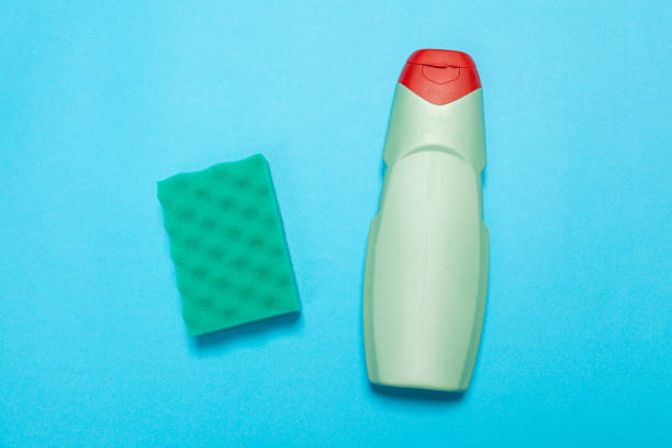 istock Detergent for various surfaces and a rag on a blue background. Professional cleaning products, general cleaning. Household chemicals 1369497175