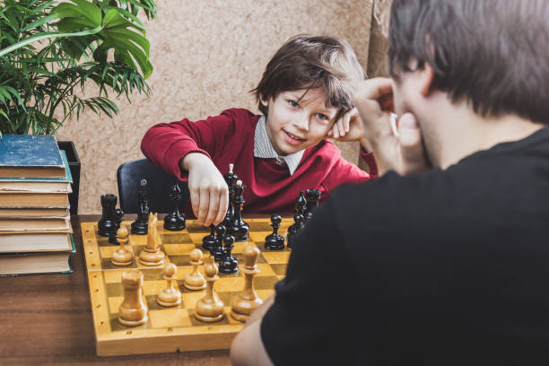 istock Father and son playing chess at home 1369503230