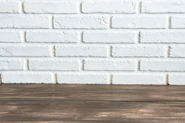 istock brick wall and wooden floor background for design, concept room. 1369504830